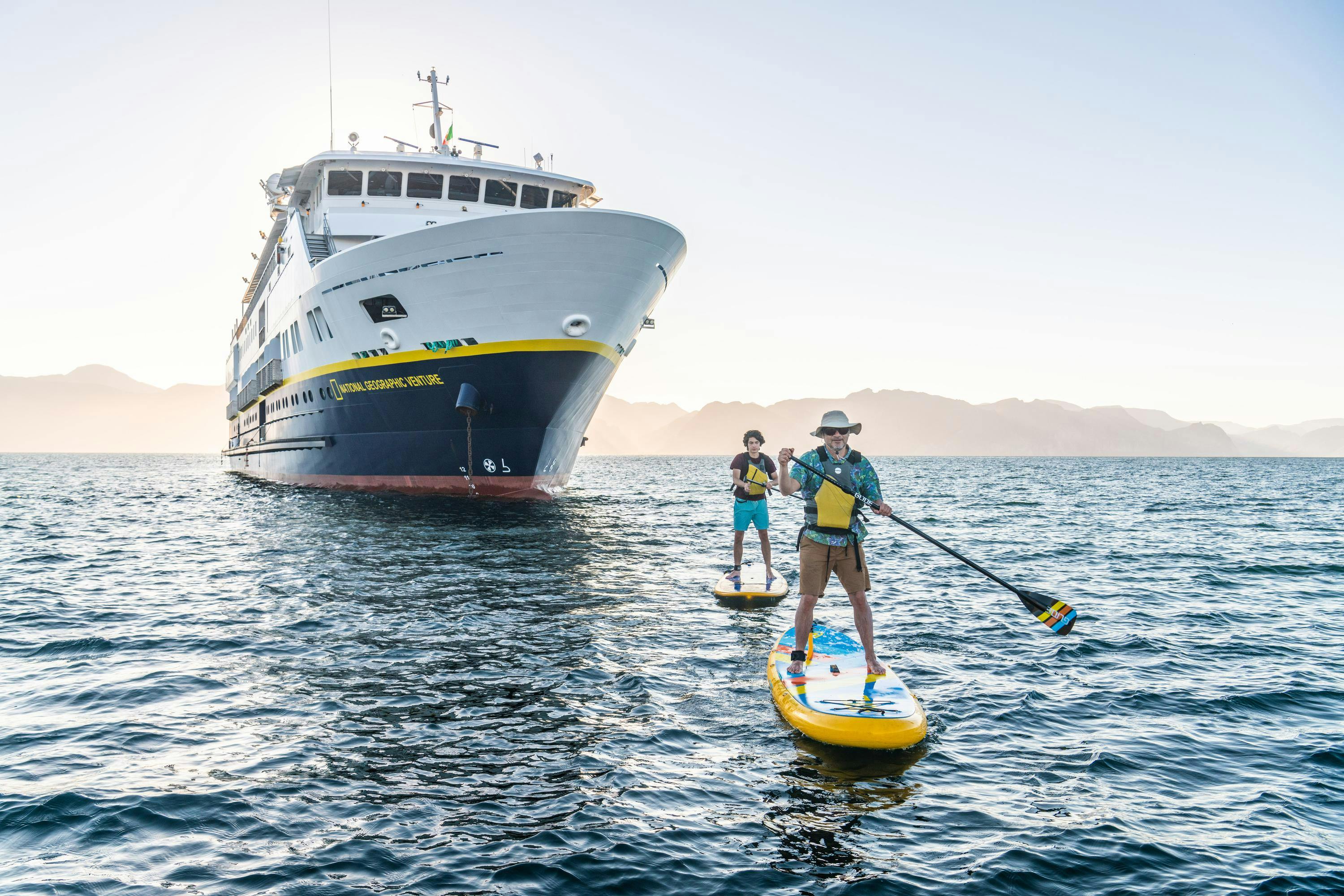 Guests Standup Paddleboarding  in San Evaristo from the ship National Geographic Venture, Baja California Sur, Mexico