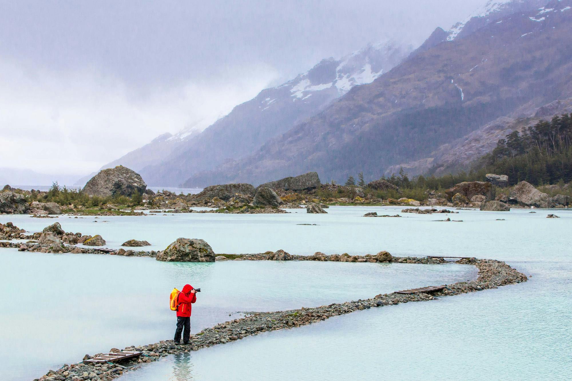 Hiker Carsten Peter on rocky path to the Bernal Glacier in Estero Las Montanas, Strait of Magellan, Patagonia, Chile.