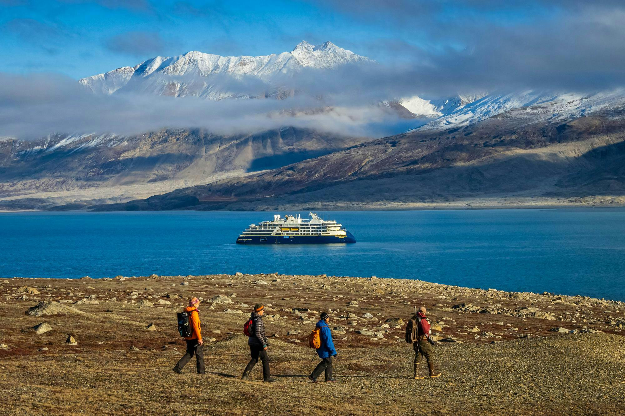 Guests hike and explorers on shore of Alpejord Fjord, Northeast Greenland National Park, Greenland