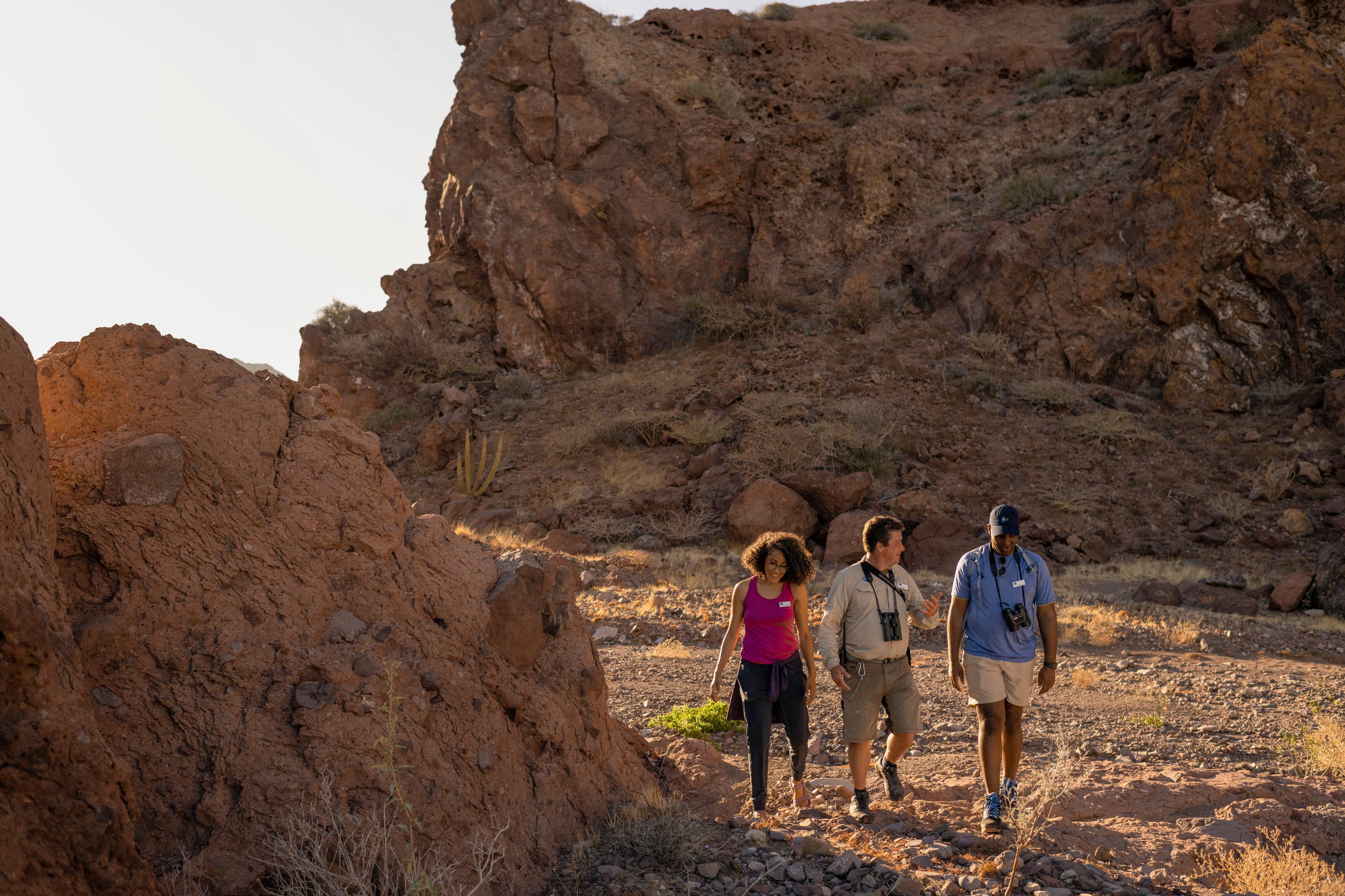 Photo instructor, Rich Reid, hiking with two guests while teaching them how to take better photos with a DSLR camera and iPhone, Isla del Carmen, Gulf of California, Mexico.