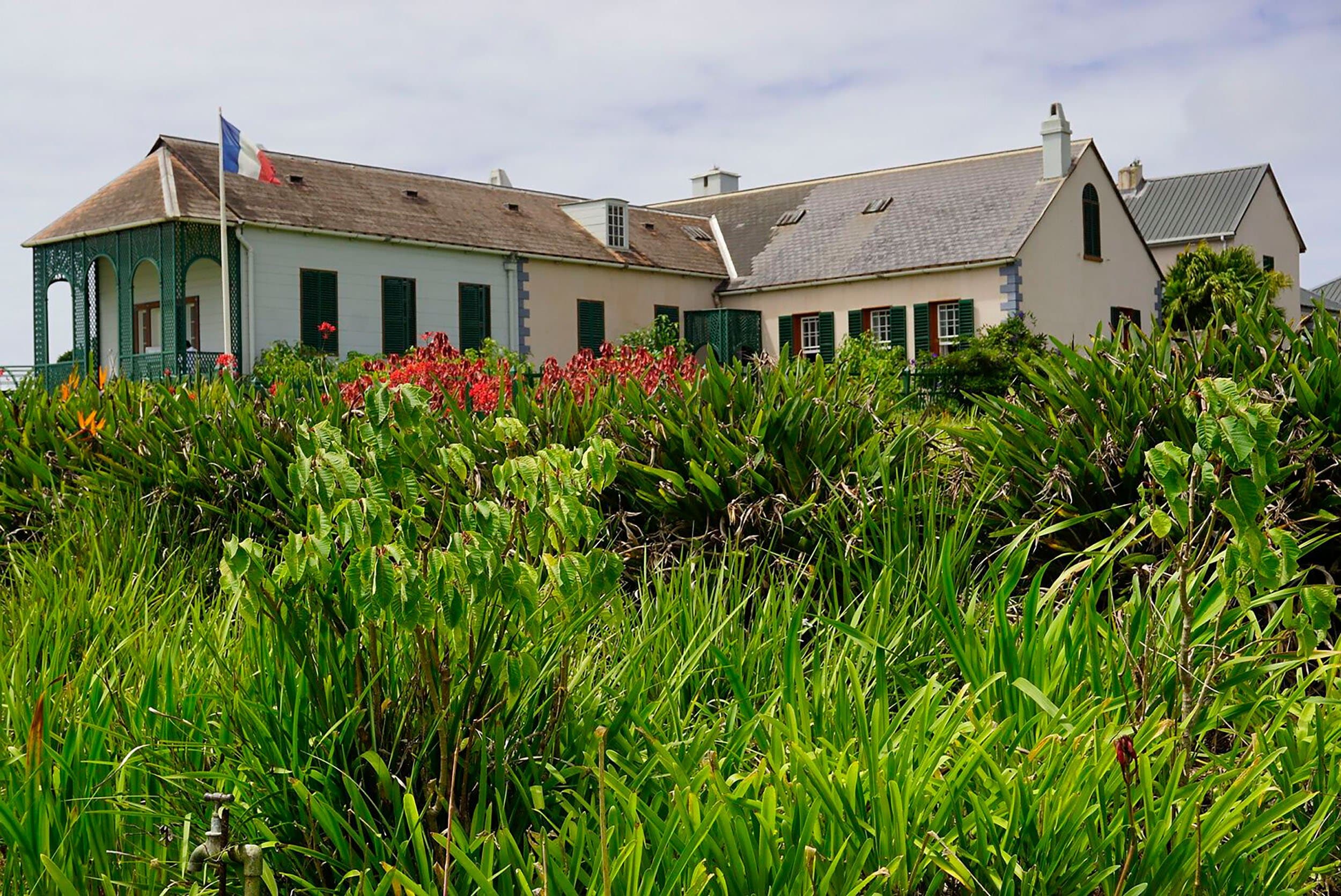 white house on a green hill