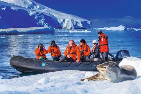 Guests exploring by zaodiac get amazing photos of a Leopard seal in Dallmann Bay, Antarctic Peninsula, Southern Ocean, Antarctica