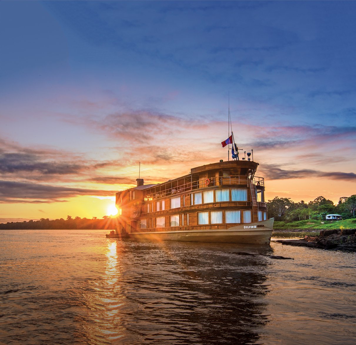 The Delfin II riverboat sails along the Amazon River
