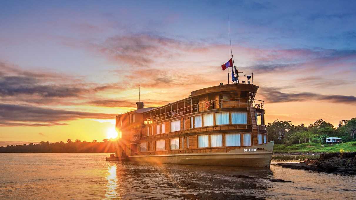 The Delfin II riverboat sails along the Amazon River