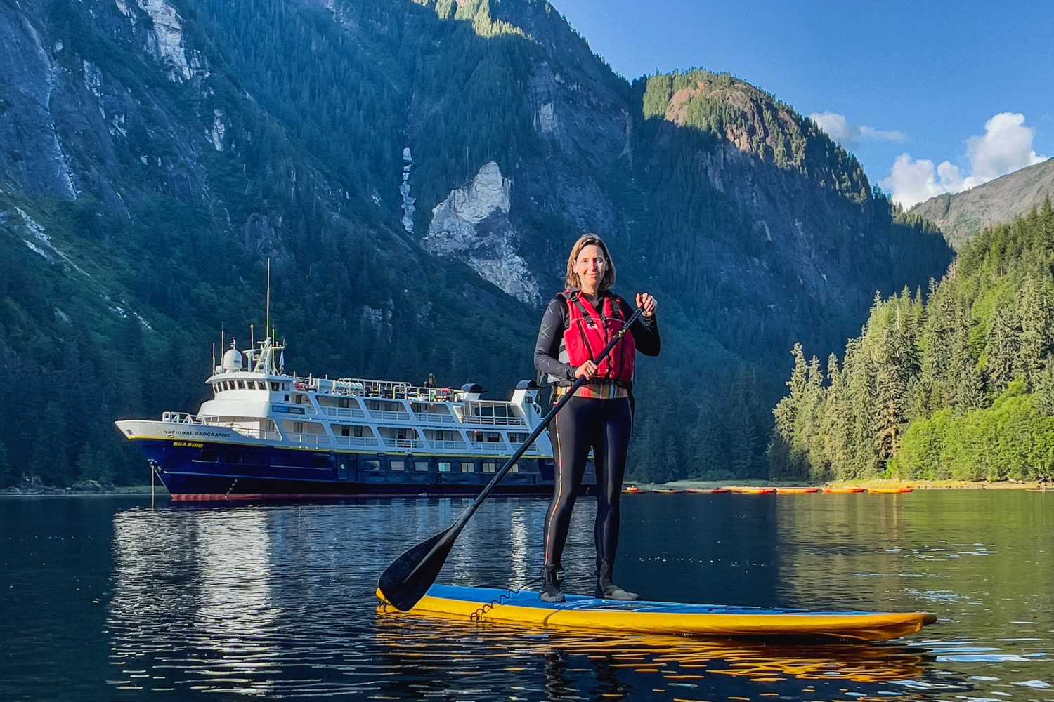 Woman on a stand-up paddleboard in Alaska