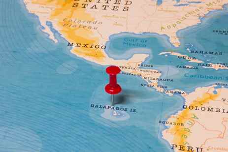 World map with a pushpin in the Galápagos Islands