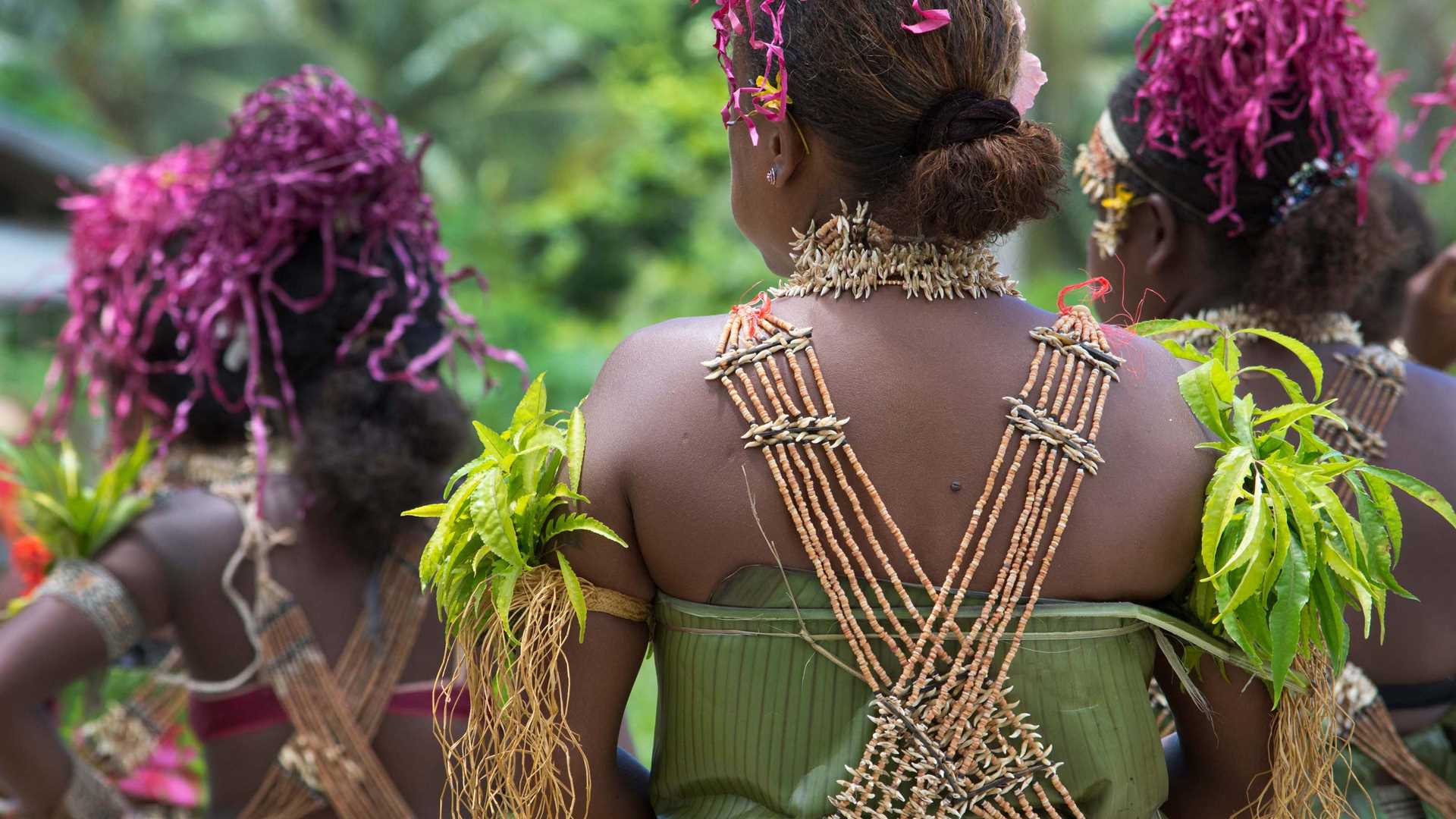 Women in traditional garb perform in the Solomon Islands