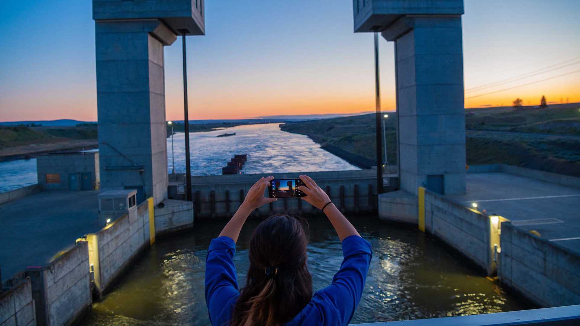 A guest snaps a photo while transiting the locks on the Columbia River