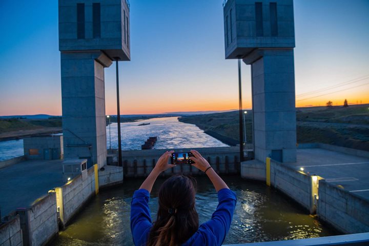 A guest snaps a photo while transiting the locks on the Columbia River