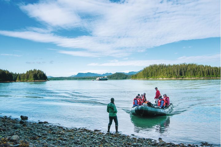 Explorers in a Zodiac come ashore in Alaska