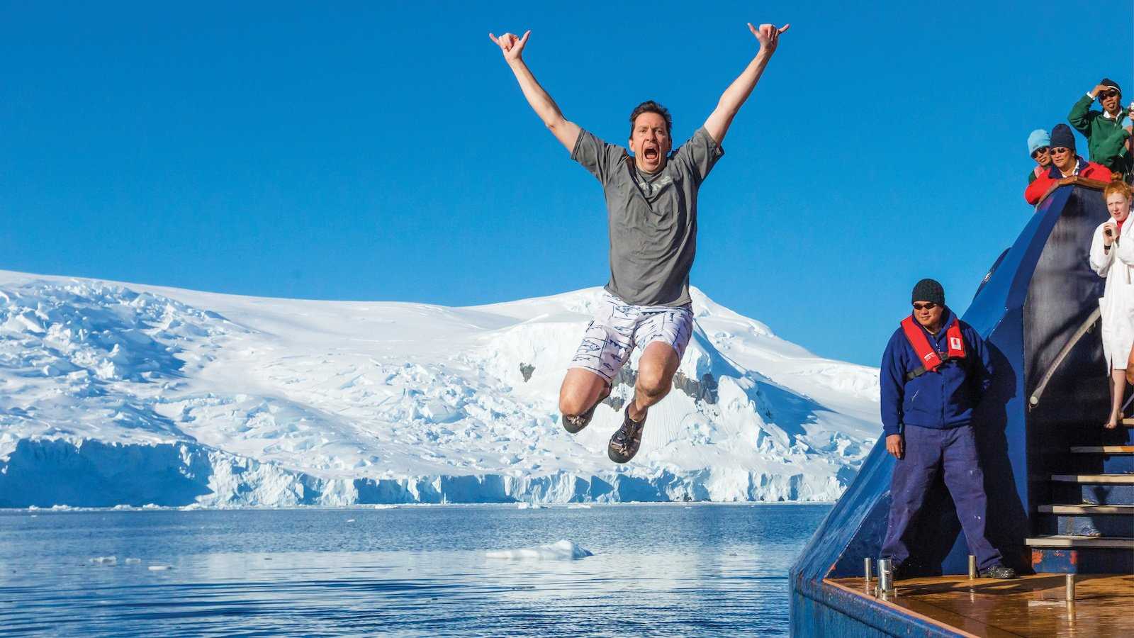 A man jumps into the polar waters on a Lindblad-National Geographic expedition