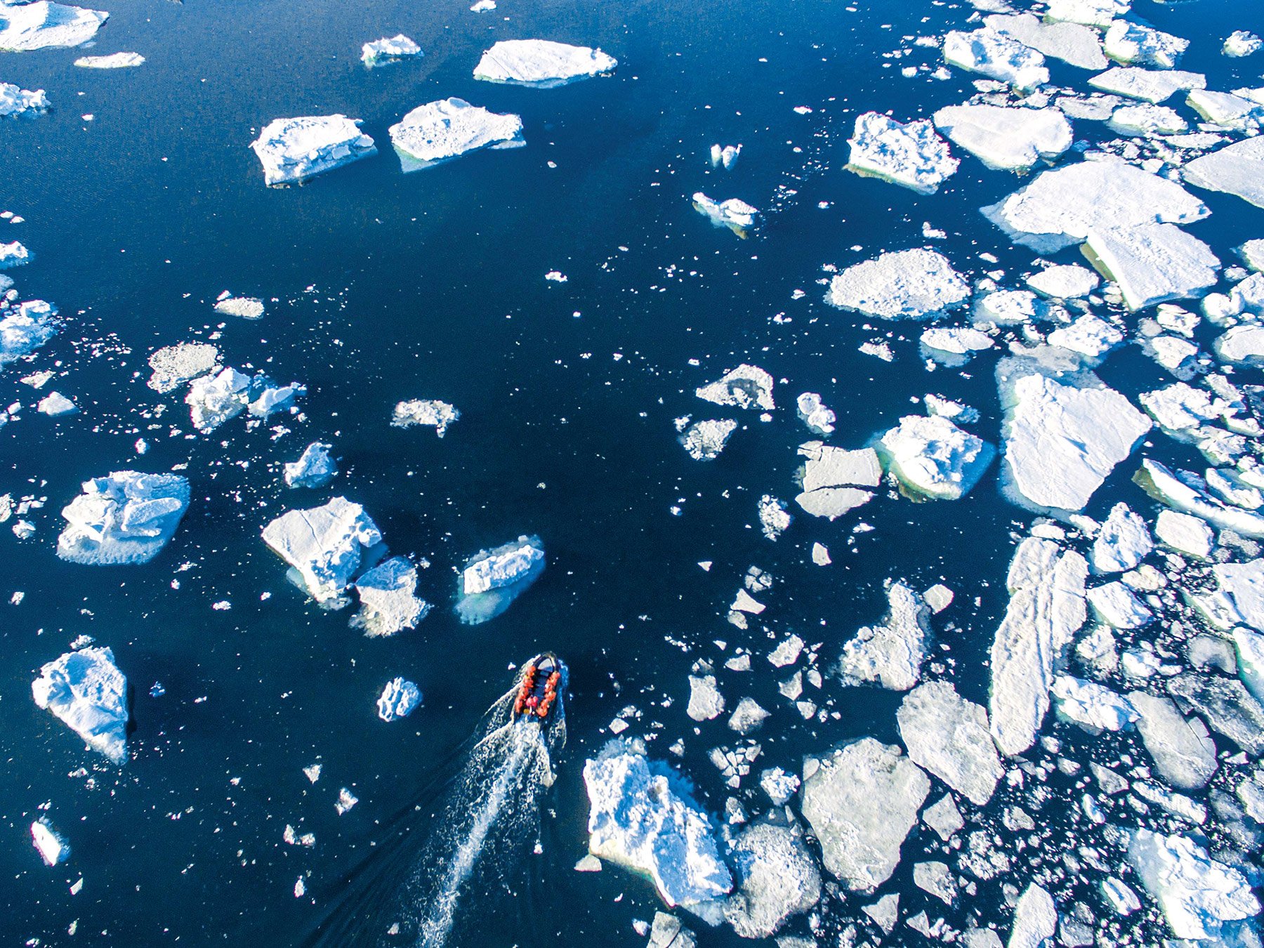 A Zodiac cruises through sea ice in the Southern Ocean