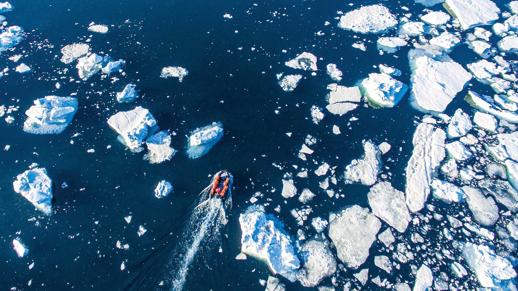 A Zodiac cruises through sea ice in the Southern Ocean