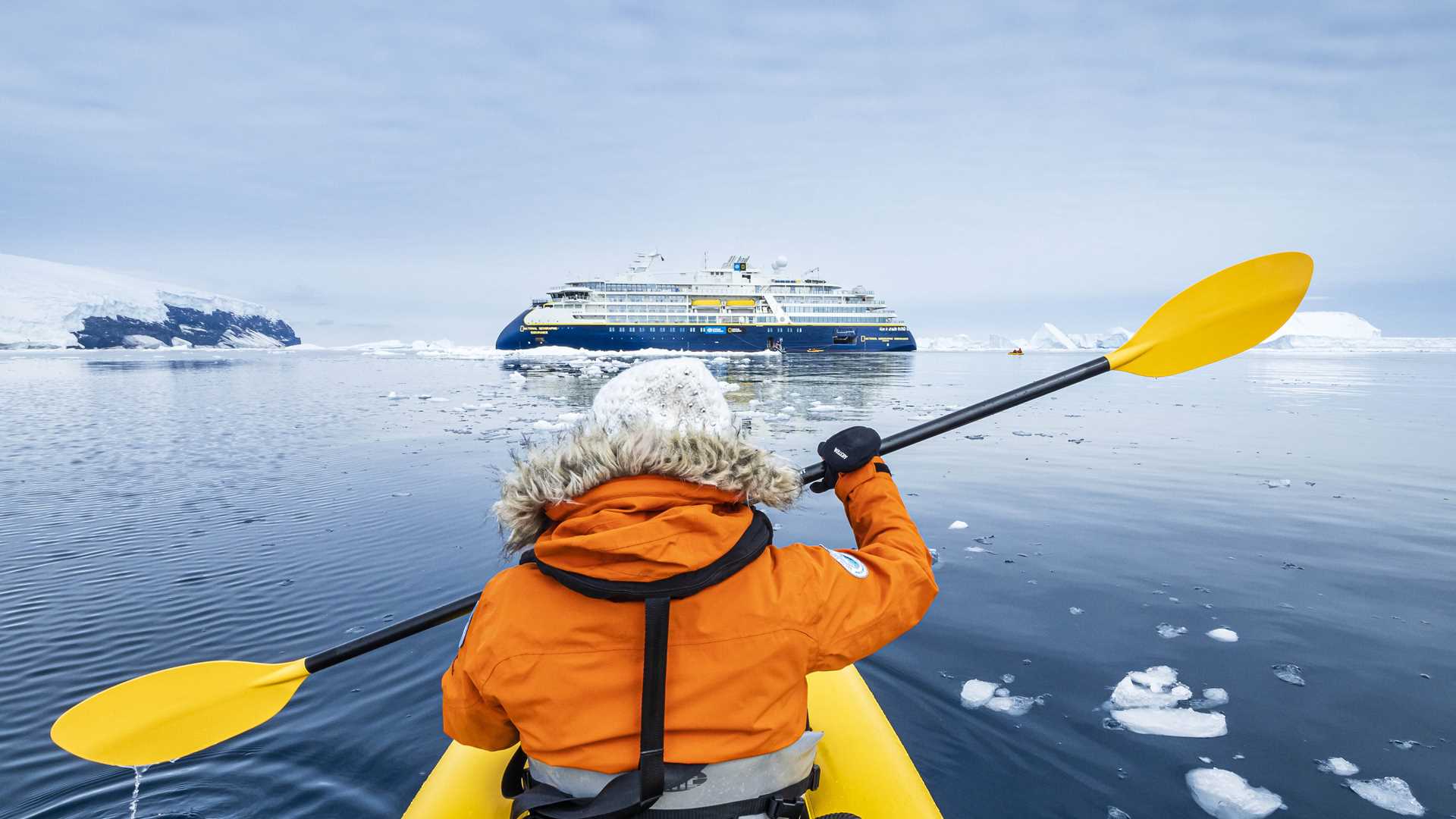 A kayaker paddles in Antarctica with the National Geographic Resolution.