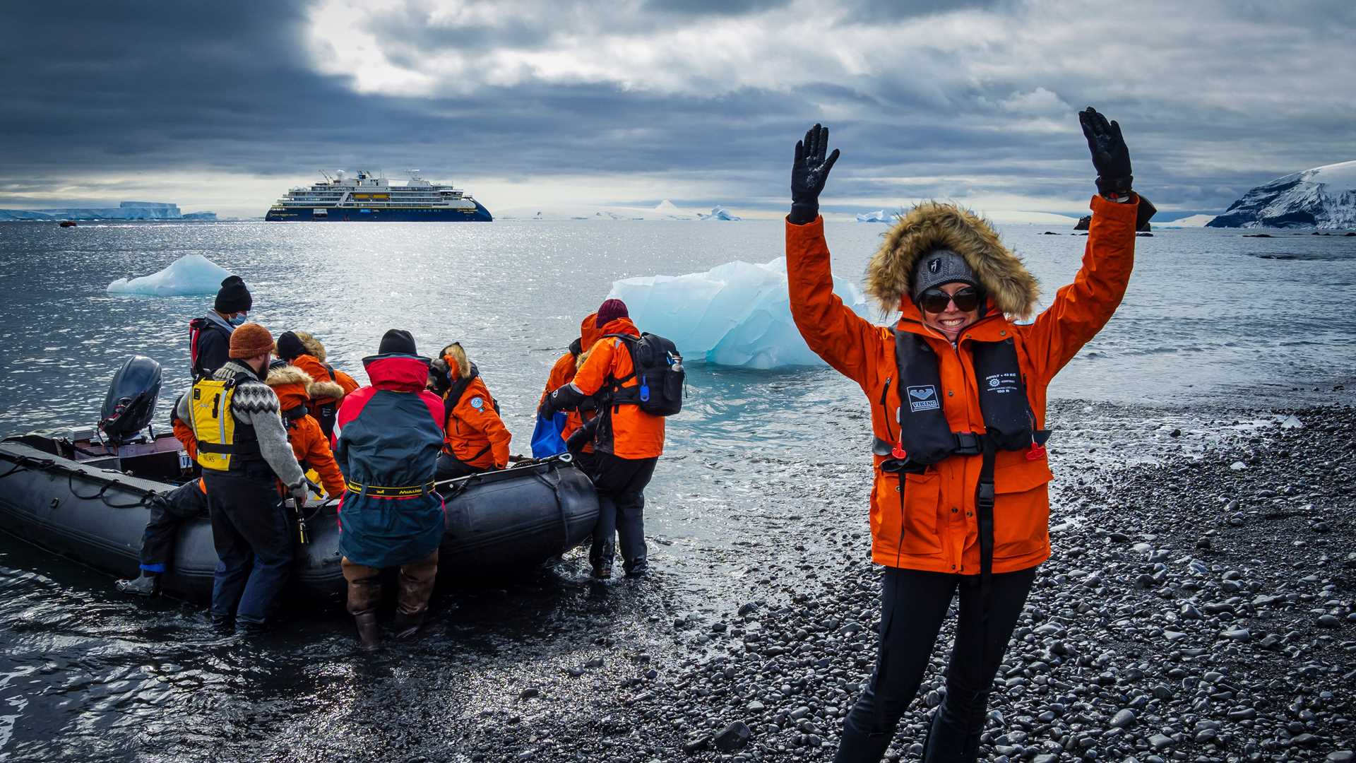 A guest celebrates after disembarking a Zodiac in Antarctica.