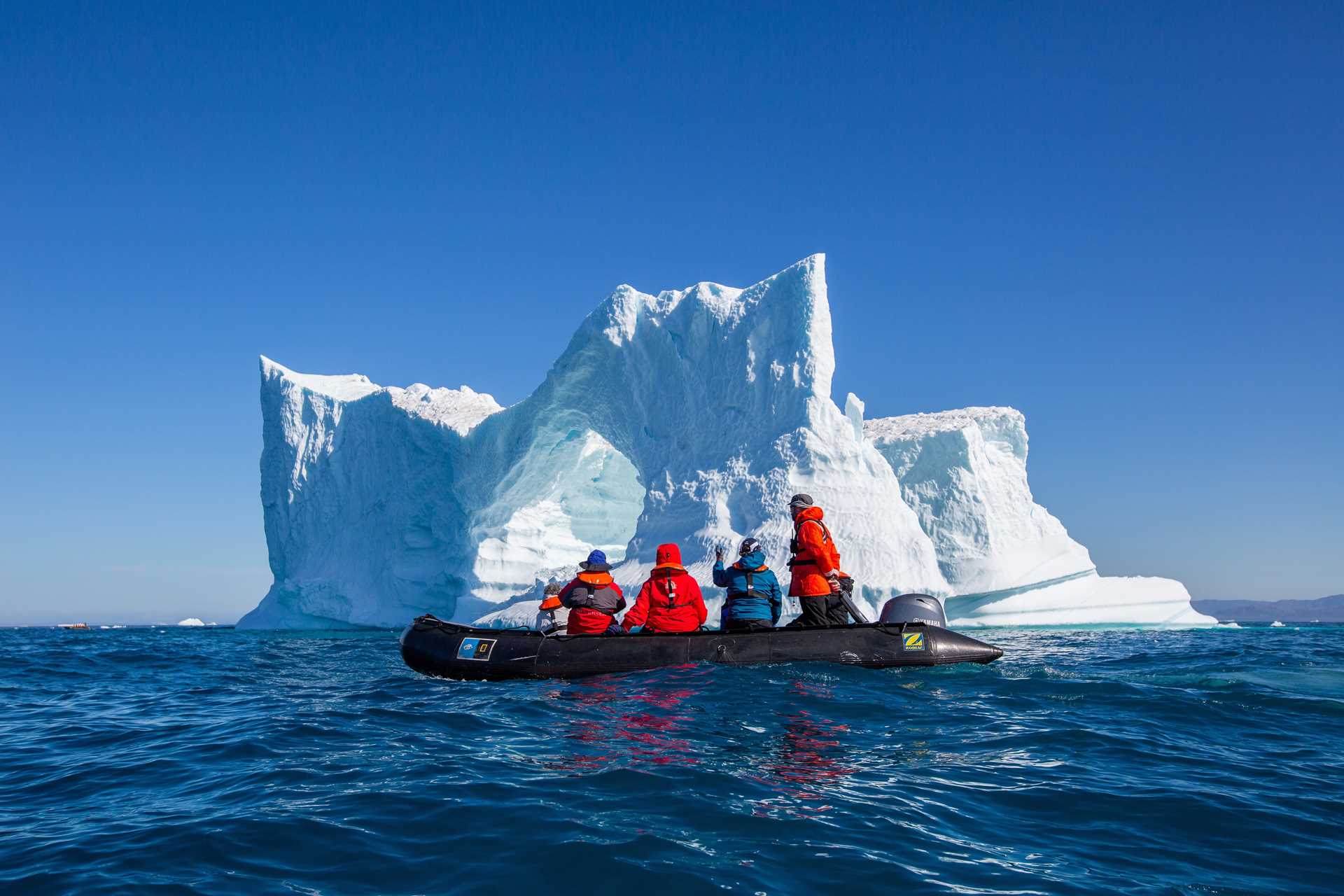 A Zodiac in front of an iceberg in Ilulissat Icefjord, Greenland