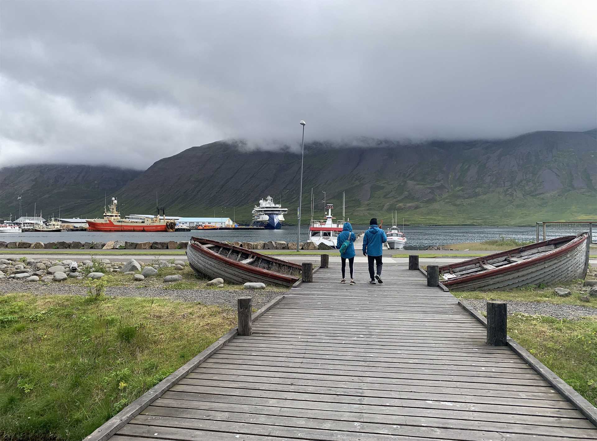 two people walking on a dock