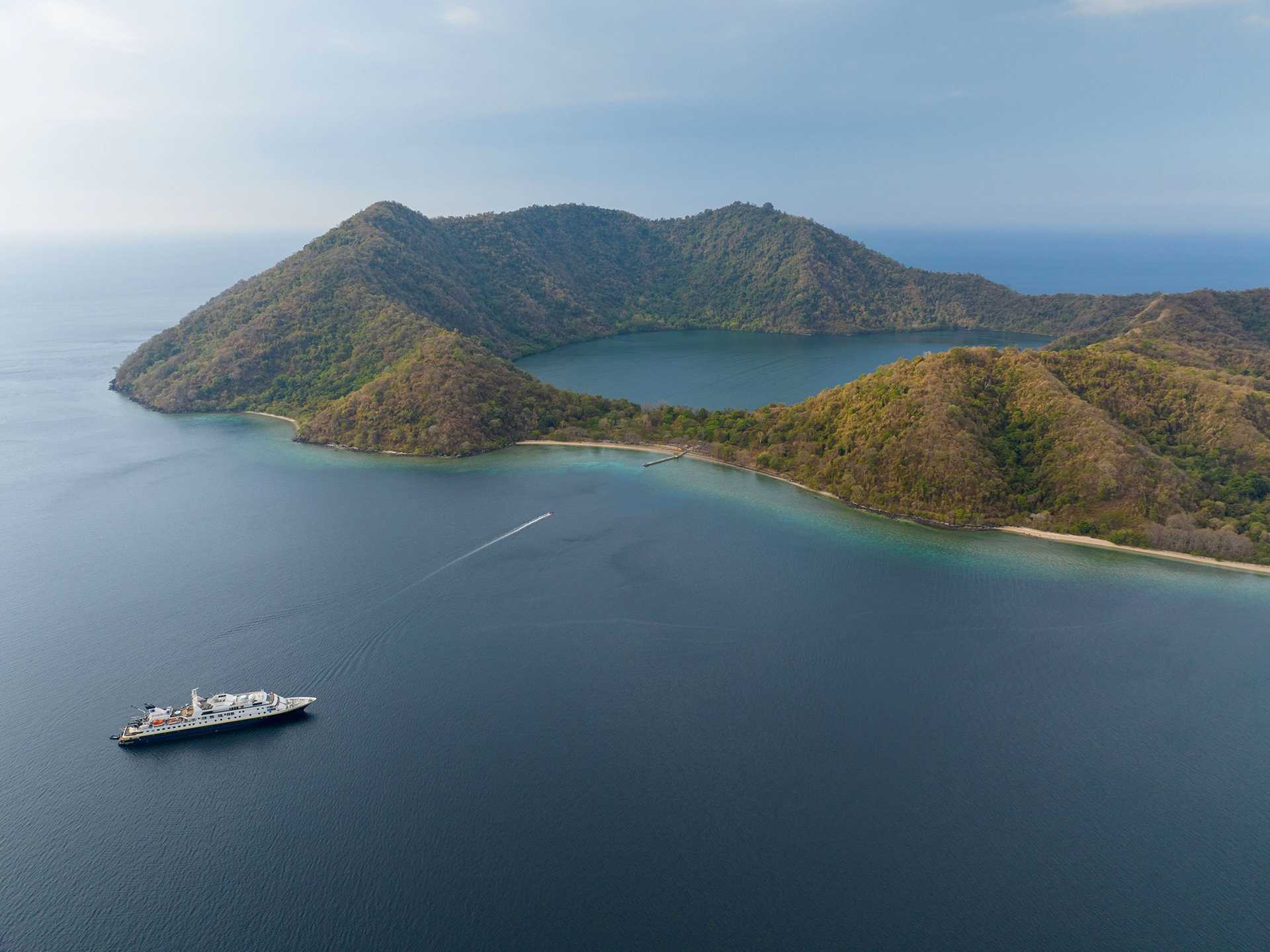 aerial view of national geographic orion parked off the coast of an Indonesian island
