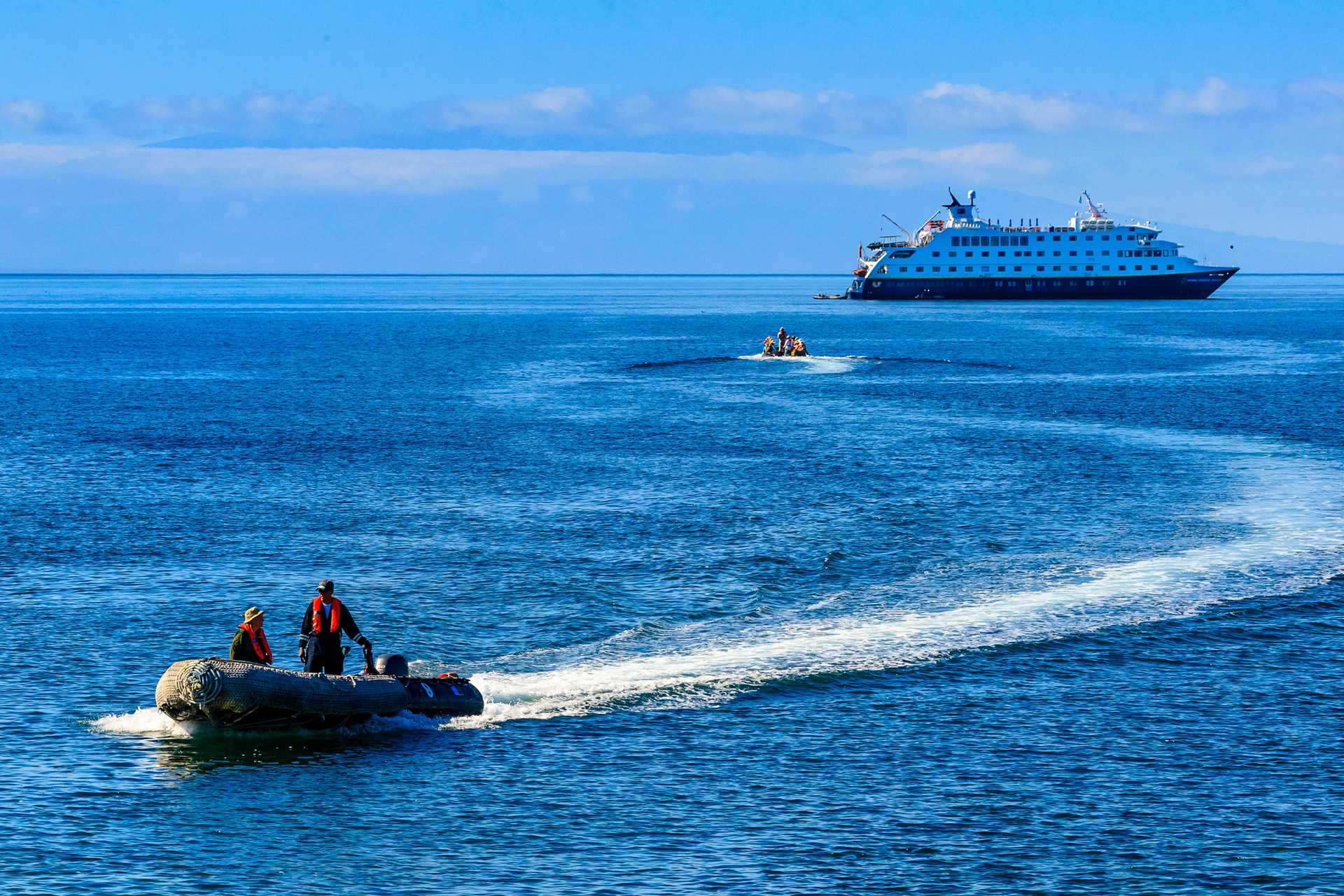 Two Zodiacs cruise away from the ship National Geographic Endeavour II.