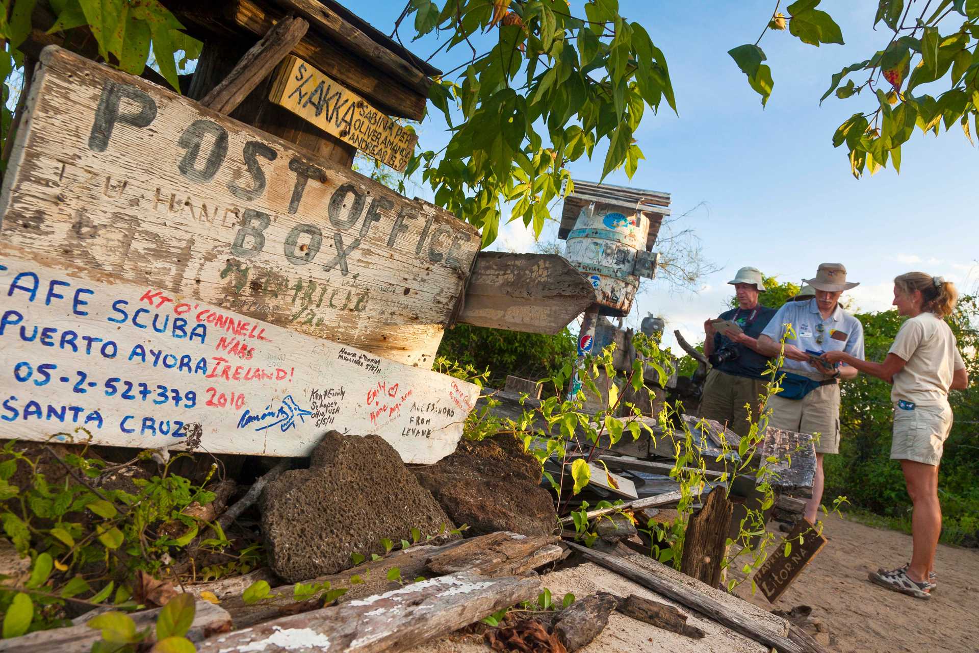 Guests leave postcards at the Post Office Bay barrel on Floreana Island.